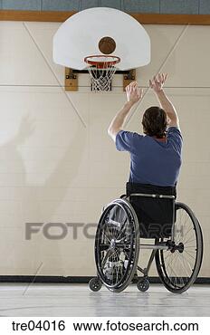 Stock Photo - wheelchair-bound 
man shooting basket. 
fotosearch - search 
stock photos, 
pictures, images, 
and photo clipart