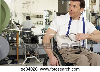 Stock Photography - wheelchair-bound 
man working out 
at gym. fotosearch 
- search stock 
photos, pictures, 
images, and photo 
clipart