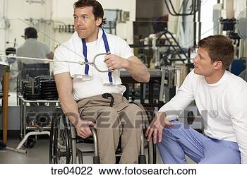 Stock Photo - wheelchair-bound 
man working out 
at gym. fotosearch 
- search stock 
photos, pictures, 
images, and photo 
clipart