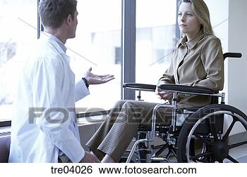 Stock Photo - wheelchair-bound 
woman talking 
to doctor. fotosearch 
- search stock 
photos, pictures, 
images, and photo 
clipart