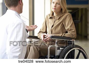 Stock Photo - wheelchair-bound 
woman talking 
to doctor. fotosearch 
- search stock 
photos, pictures, 
images, and photo 
clipart