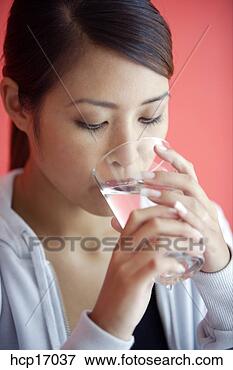 Picture - asian woman drinking 
glass of water. 
fotosearch - search 
stock photos, 
pictures, images, 
and photo clipart