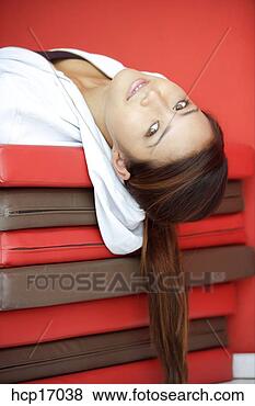 Stock Photo - asian woman relaxing 
on mats. fotosearch 
- search stock 
photos, pictures, 
images, and photo 
clipart