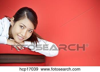 Stock Photograph - asian woman relaxing 
on mats. fotosearch 
- search stock 
photos, pictures, 
images, and photo 
clipart