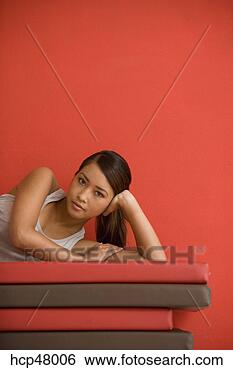 Stock Photo - woman laying on 
exercise mats. 
fotosearch - search 
stock photos, 
pictures, images, 
and photo clipart