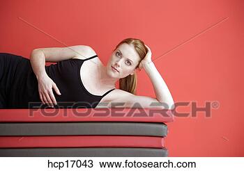 Stock Photo - woman laying on 
mats. fotosearch 
- search stock 
photos, pictures, 
images, and photo 
clipart