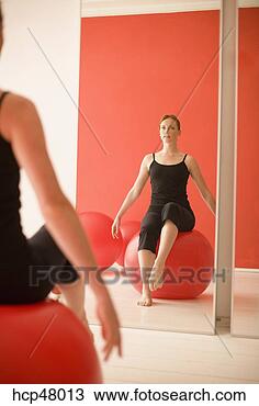Stock Photo - woman sitting 
on exercise ball. 
fotosearch - search 
stock photos, 
pictures, images, 
and photo clipart