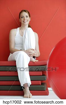 Stock Photo - woman sitting 
on mats. fotosearch 
- search stock 
photos, pictures, 
images, and photo 
clipart