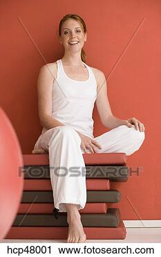Stock Photography - woman sitting 
on mats. fotosearch 
- search stock 
photos, pictures, 
images, and photo 
clipart