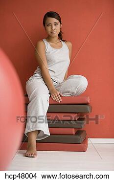 Stock Photo - woman sitting 
on mats. fotosearch 
- search stock 
photos, pictures, 
images, and photo 
clipart