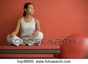 Stock Image - woman sitting 
on mats. fotosearch 
- search stock 
photos, pictures, 
images, and photo 
clipart