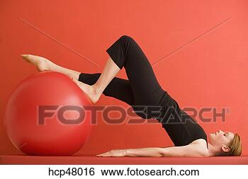 Stock Photo - woman using exercise 
ball. fotosearch 
- search stock 
photos, pictures, 
images, and photo 
clipart