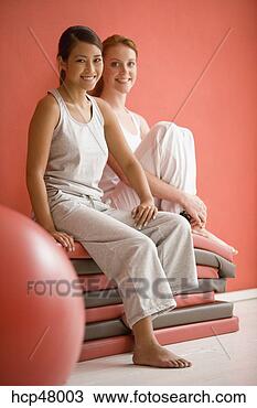 Stock Photo - women sitting 
on mats. fotosearch 
- search stock 
photos, pictures, 
images, and photo 
clipart