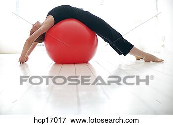 Picture - young woman stretching 
on exercise ball. 
fotosearch - search 
stock photos, 
pictures, images, 
and photo clipart