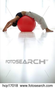 Stock Photo - young woman stretching 
on exercise ball. 
fotosearch - search 
stock photos, 
pictures, images, 
and photo clipart