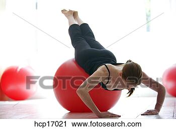 Stock Photography - young woman stretching 
on exercise ball. 
fotosearch - search 
stock photos, 
pictures, images, 
and photo clipart