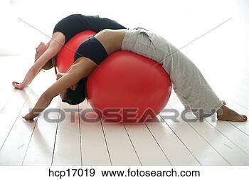 Stock Photograph - young women stretching 
on exercise balls. 
fotosearch - search 
stock photos, 
pictures, images, 
and photo clipart