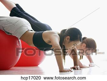 Stock Photography - young women stretching 
on exercise balls. 
fotosearch - search 
stock photos, 
pictures, images, 
and photo clipart