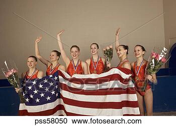 Stock Photography - swim team holding 
american flag 
and waving in 
celebration. fotosearch 
- search stock 
photos, pictures, 
images, and photo 
clipart
