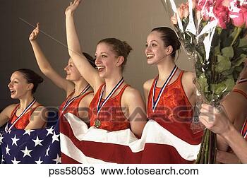 Stock Photo - swim team holding 
american flag 
and waving in 
celebration. fotosearch 
- search stock 
photos, pictures, 
images, and photo 
clipart