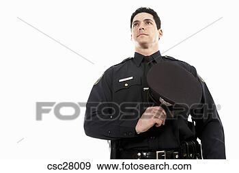 Arquivo Fotográficos - macho,  polícia, 
 oficial,  segurando, 
 seu,  chapéu, 
 seu,  peito. 
fotosearch - busca 
de fotos, imagens 
e clipart