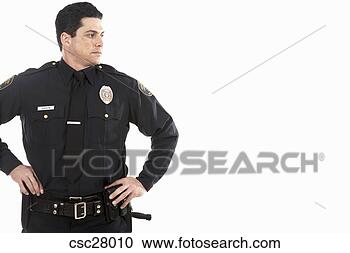 Arquivo de Fotografias - macho,  polícia, 
 oficial,  ficar, 
 mãos,  quadris. 
fotosearch - busca 
de fotos, imagens 
e clipart