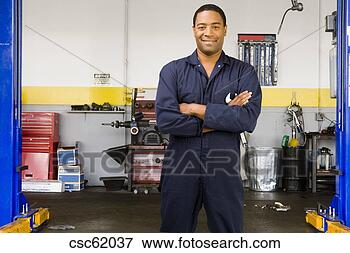 Picture - african male auto 
mechanic in shop. 
fotosearch - search 
stock photos, 
pictures, images, 
and photo clipart