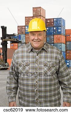 Stock Photograph - male dock worker 
in front of cargo 
containers. fotosearch 
- search stock 
photos, pictures, 
images, and photo 
clipart