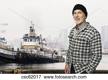 Picture - senior male fisherman 
in front of fishing 
boat. fotosearch 
- search stock 
photos, pictures, 
images, and photo 
clipart