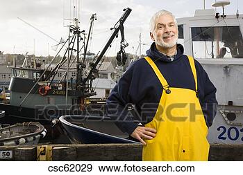 Stock Photograph - senior male fisherman 
in front of fishing 
boat. fotosearch 
- search stock 
photos, pictures, 
images, and photo 
clipart