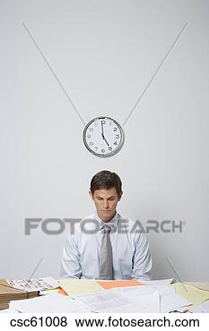 Stock Photo - businessman at 
desk covered in 
paperwork. fotosearch 
- search stock 
photos, pictures, 
images, and photo 
clipart