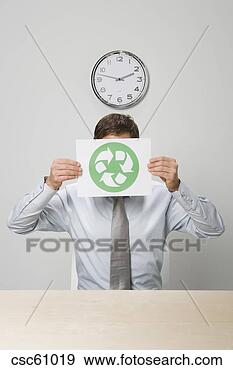 Stock Photograph - businessman holding 
recycling sign 
in front of face. 
fotosearch - search 
stock photos, 
pictures, images, 
and photo clipart