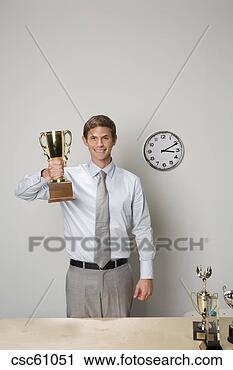 Stock Photography - businessman holding 
trophy. fotosearch 
- search stock 
photos, pictures, 
images, and photo 
clipart