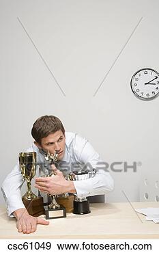 Stock Photograph - businessman hugging 
trophies. fotosearch 
- search stock 
photos, pictures, 
images, and photo 
clipart