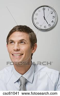 Stock Photography - businessman next 
to wall clock. 
fotosearch - search 
stock photos, 
pictures, images, 
and photo clipart