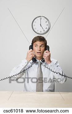 Stock Photo - businessman talking 
on two telephones. 
fotosearch - search 
stock photos, 
pictures, images, 
and photo clipart