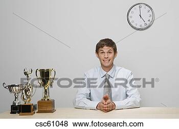 Stock Photo - businessman with 
trophies on desk. 
fotosearch - search 
stock photos, 
pictures, images, 
and photo clipart