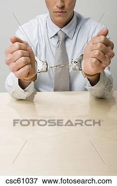 Picture - close up of businessman 
in handcuffs. 
fotosearch - search 
stock photos, 
pictures, images, 
and photo clipart