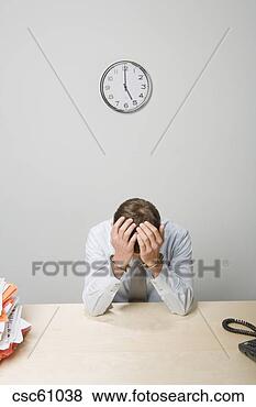 Stock Photo - handcuffed businessman 
with head in hands. 
fotosearch - search 
stock photos, 
pictures, images, 
and photo clipart