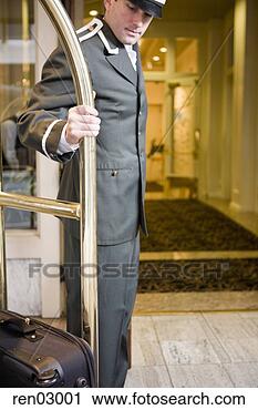 Stock Photography - bellhop pulling 
luggage cart. 
fotosearch - search 
stock photos, 
pictures, images, 
and photo clipart