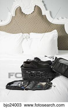 Stock Photo - businessman's 
packed suitcase 
on bed. fotosearch 
- search stock 
photos, pictures, 
images, and photo 
clipart