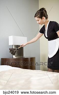 Stock Photograph - maid dusting night 
stand. fotosearch 
- search stock 
photos, pictures, 
images, and photo 
clipart