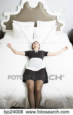 Stock Photo - maid laying on 
bed. fotosearch 
- search stock 
photos, pictures, 
images, and photo 
clipart