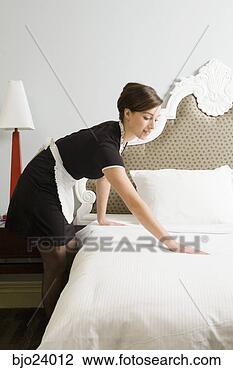 Stock Photo - maid making bed. 
fotosearch - search 
stock photos, 
pictures, images, 
and photo clipart
