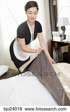 Stock Photo - maid making bed. 
fotosearch - search 
stock photos, 
pictures, images, 
and photo clipart