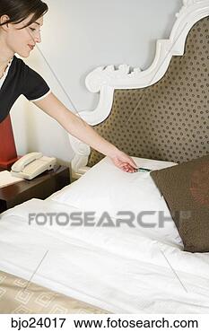 Picture - maid putting mint 
on pillow. fotosearch 
- search stock 
photos, pictures, 
images, and photo 
clipart
