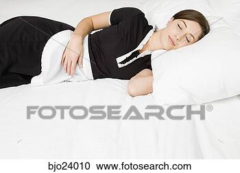 Stock Photography - maid sleeping  on bed. fotosearch  - search stock  photos, pictures,  images, and photo  clipart