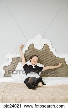 Stock Photography - maid stretching 
in bed. fotosearch 
- search stock 
photos, pictures, 
images, and photo 
clipart