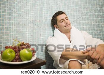 Stock Photography - man in bathrobe 
leaning on tile 
wall. fotosearch 
- search stock 
photos, pictures, 
images, and photo 
clipart
