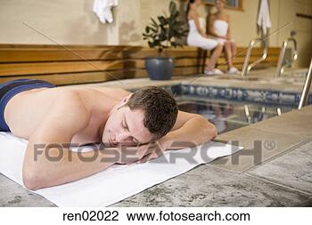 Stock Photo - man laying  next 
to hot tub. fotosearch 
- search stock 
photos, pictures, 
images, and photo 
clipart
